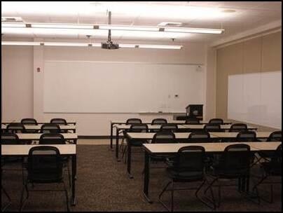 May contain: people, person, white board, indoors, architecture, building, classroom, room, and school