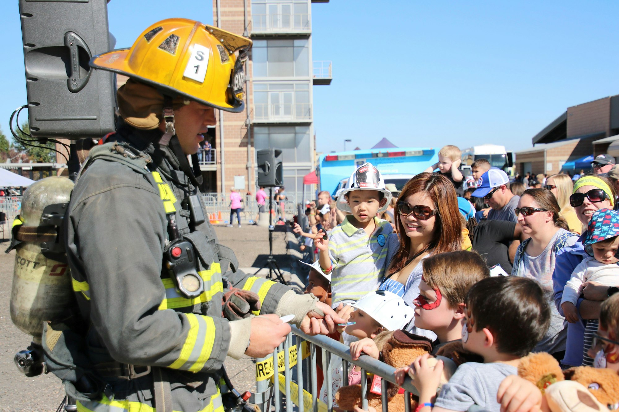 West Metro recruit, dressed in full bunker gear, talking to the crowd at the West Metro Family Fire Muster.