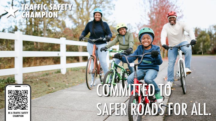A diverse group of people riding bicycles outdoors, promoting traffic safety with the message "Committed to safer roads for all."