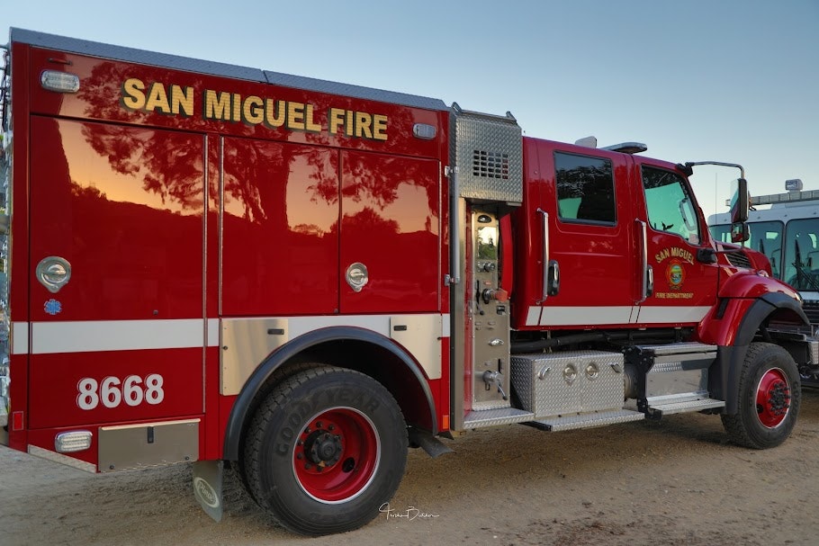 A red "San Miguel Fire" department truck, with the number 8668, parked outdoors.