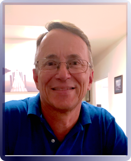 Don Elias, wearing a blue polo shirt, glasses and a smile