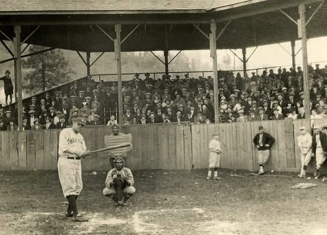 picture from pictures mound, Babe Ruth, catcher, umpire, some players in front of grand stand and full grandstand of people.