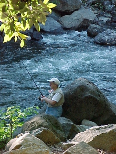 Lady fishing on Sacramento River in the Dunsmuir City Park.