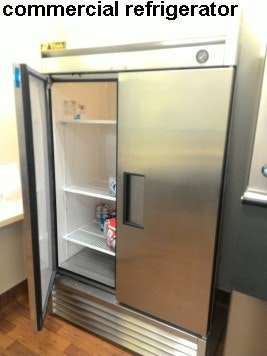 inside updated community building showing new commercial refrigerator with two doors