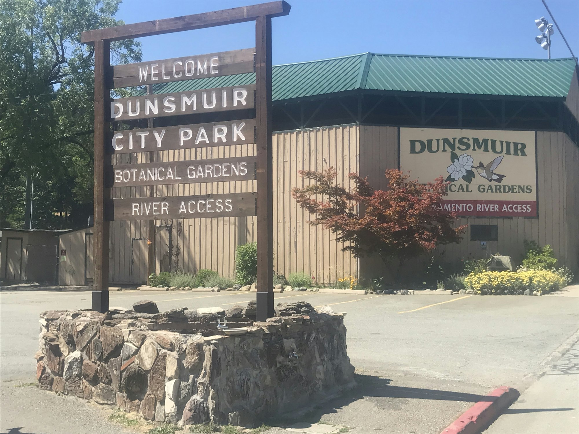 This is a picture of the new City Park entrance sign with the Ballfield Grandstand in the background.