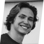 The image features a young man with wavy hair, smiling and looking towards the camera against a simple background.