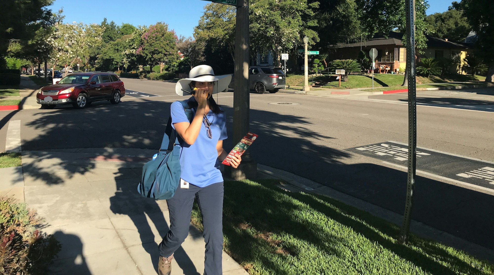 May contain: clothing, hat, person, car, transportation, vehicle, accessories, bag, handbag, sun hat, footwear, shoe, and glasses