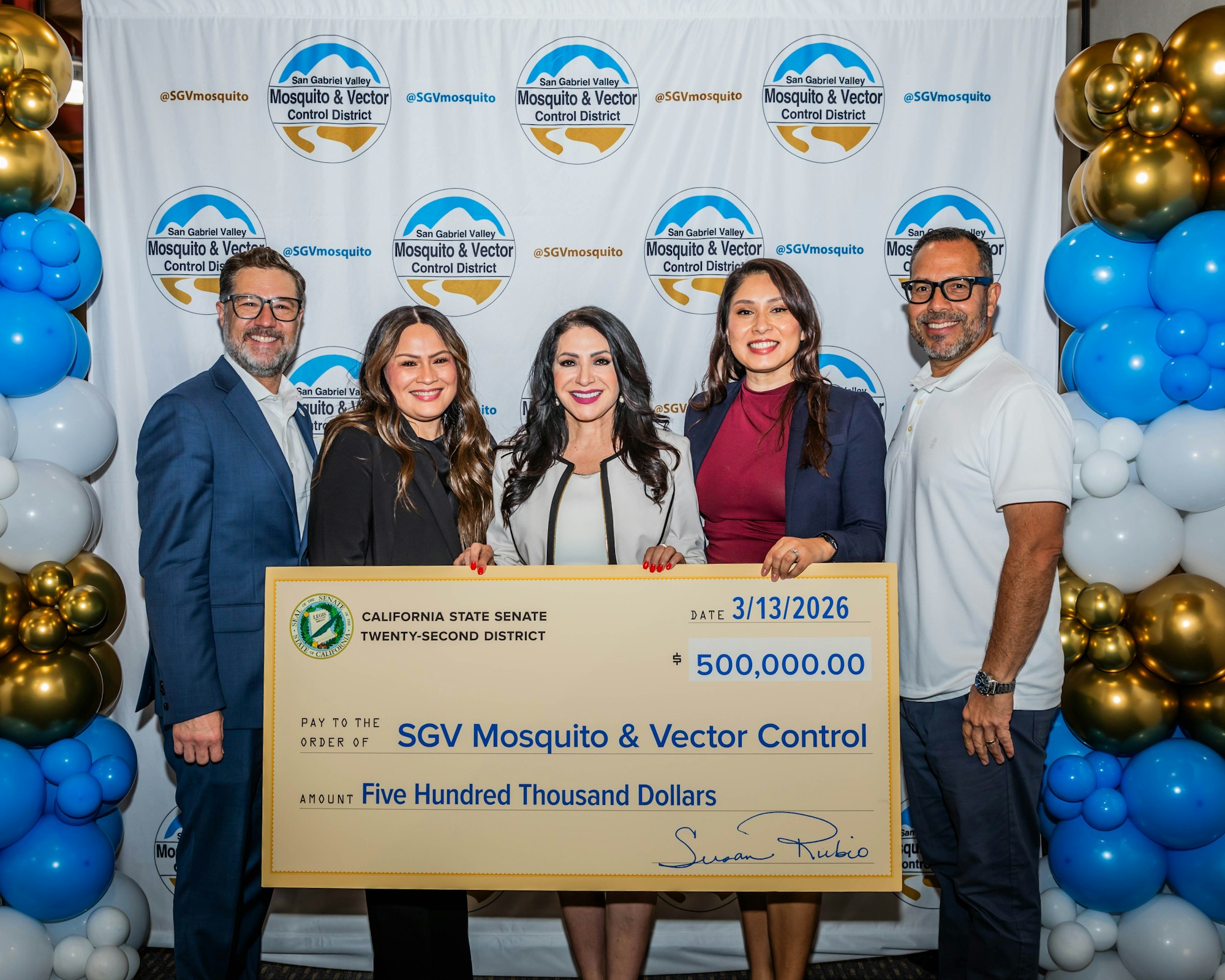 A group holding a large check for $500,000 for the SGV Mosquito & Vector Control District, with a celebratory backdrop.