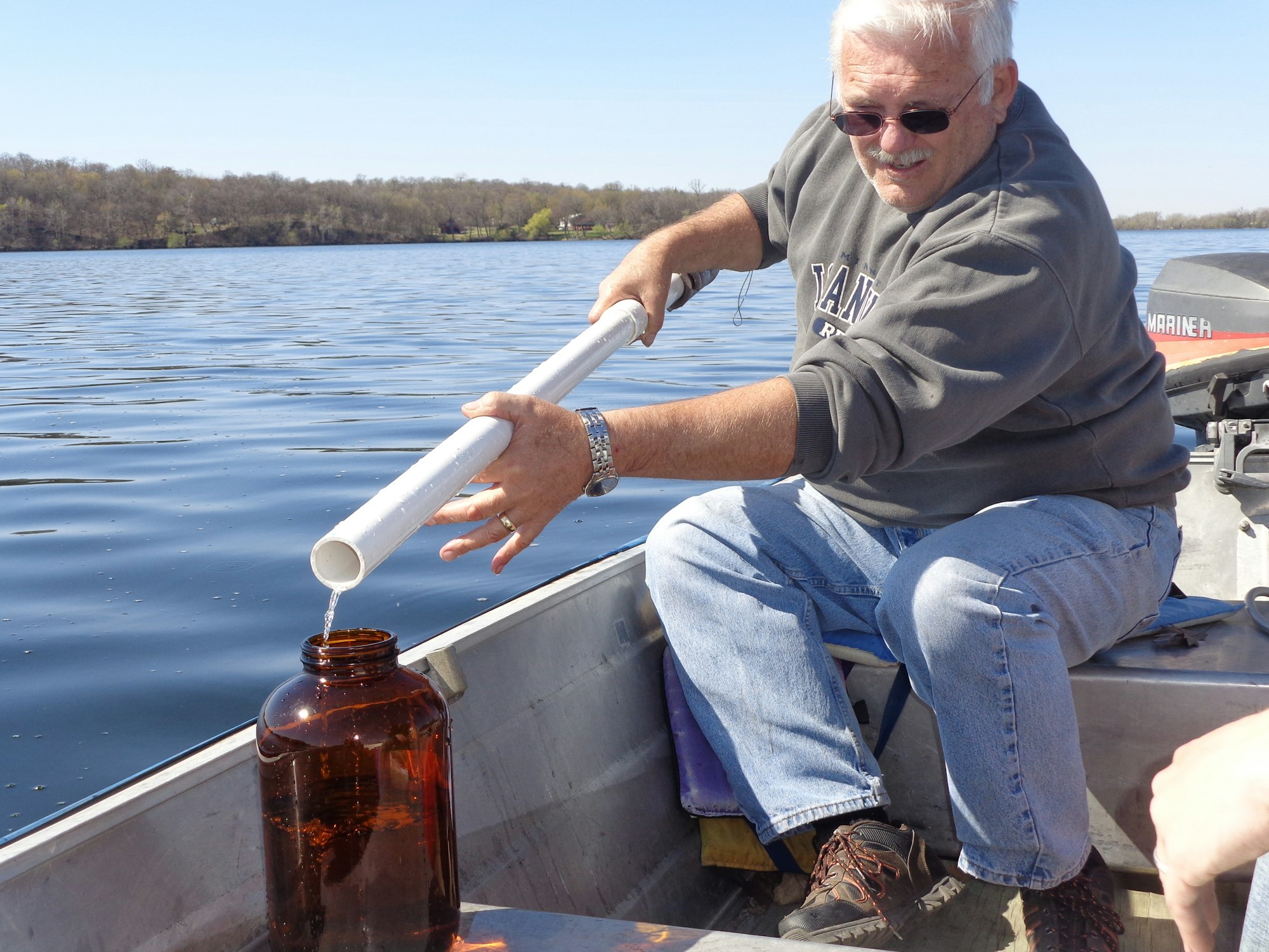May contain: alcohol, beer, beverage, wristwatch, adult, male, man, person, clothing, footwear, shoe, accessories, jewelry, ring, pants, beer bottle, bottle, liquor, transportation, vehicle, watercraft, and glasses