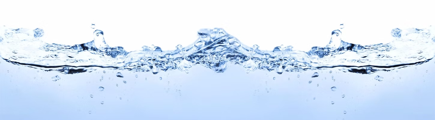 Clear water splash with air bubbles against a white background.