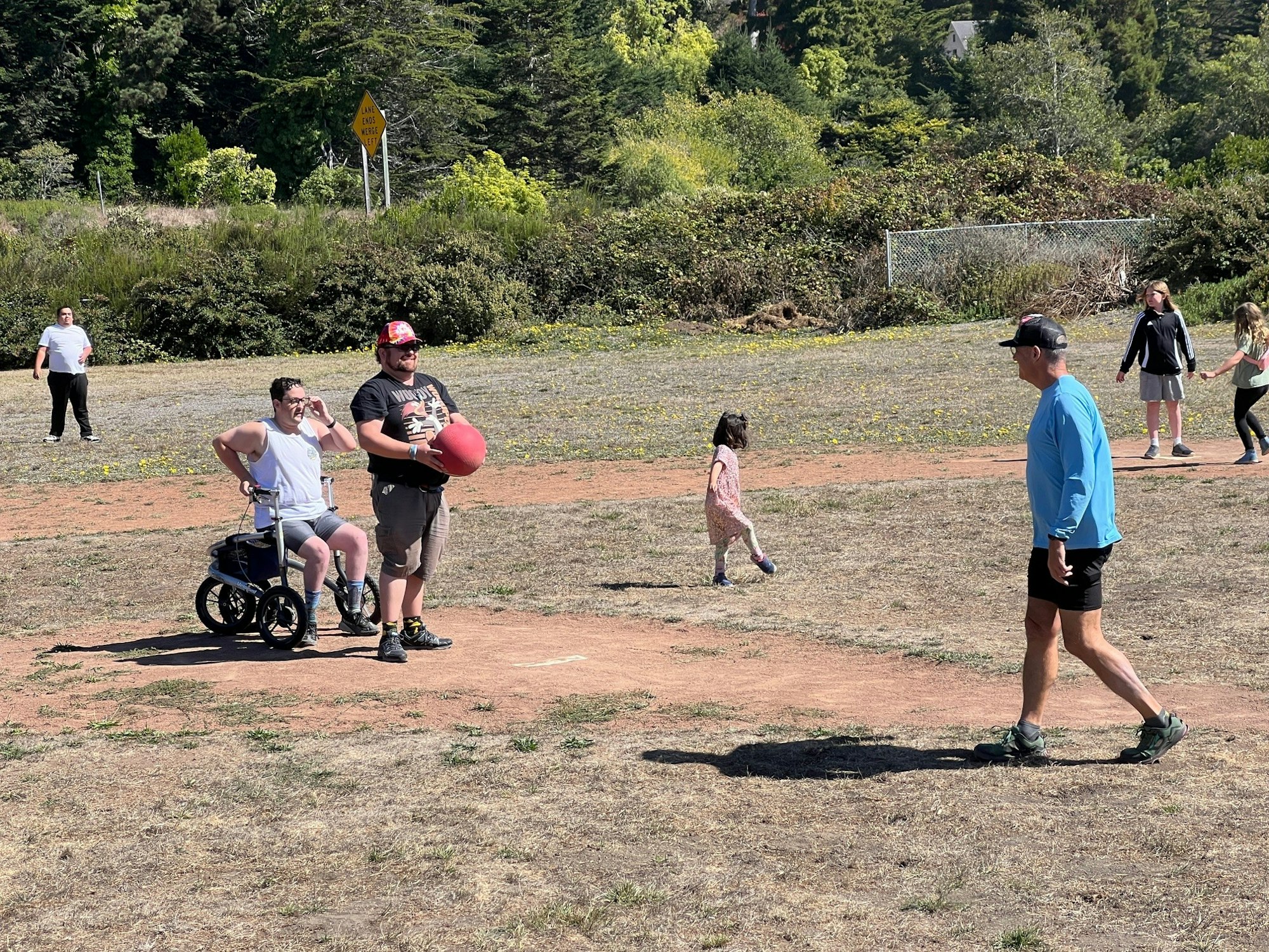 People enjoying sunny outdoor activities on a field.
