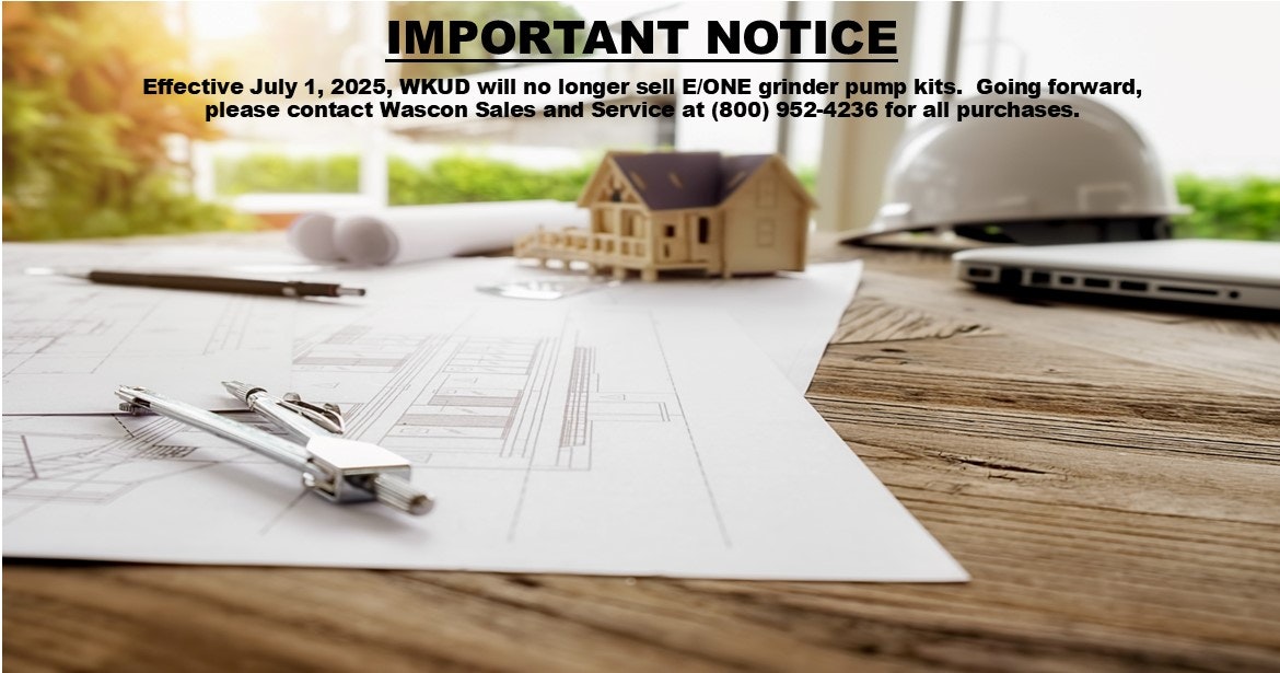 Blueprints, a model house, a compass, a hard hat, and a laptop are on a table alongside a notice about WKUD grinder pump kit sales.