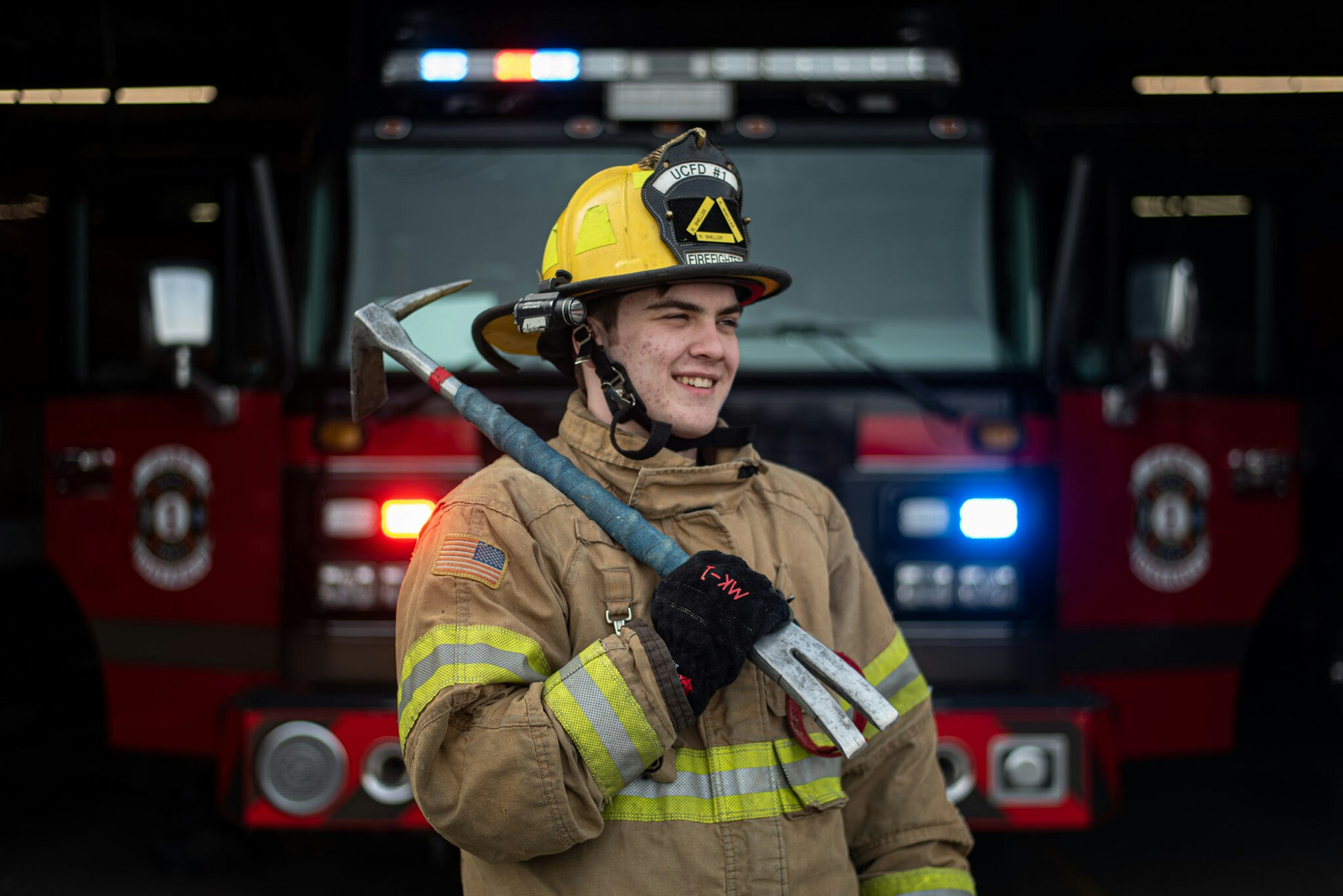 May contain: fireman, person, clothing, glove, adult, male, man, electronics, and speaker
