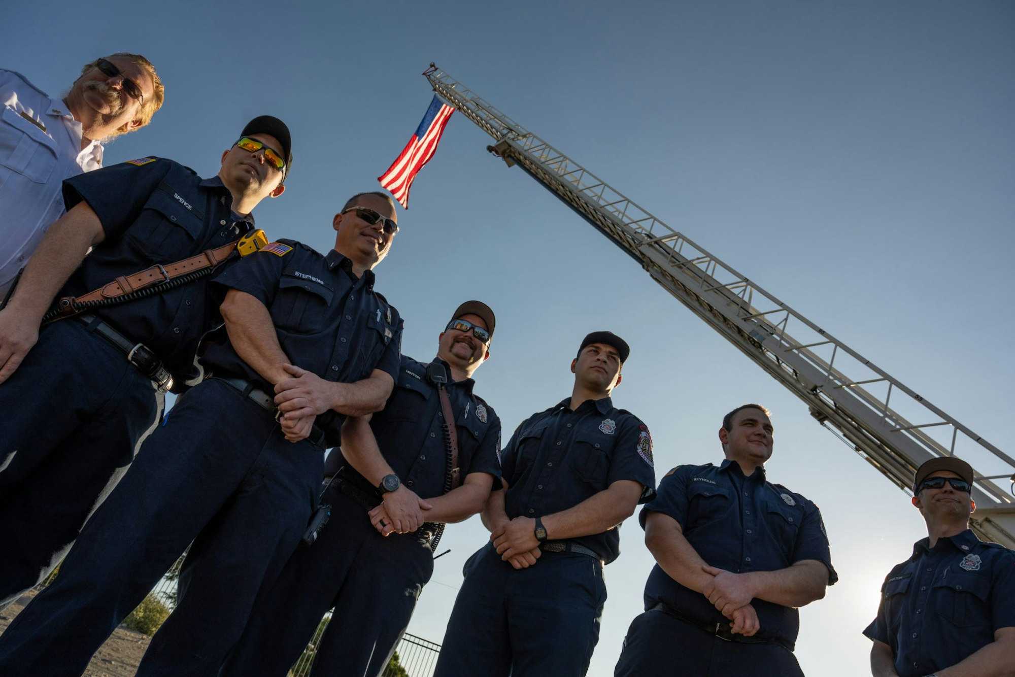 May contain: people, person, adult, male, man, officer, police officer, accessories, glasses, flag, clothing, and hat