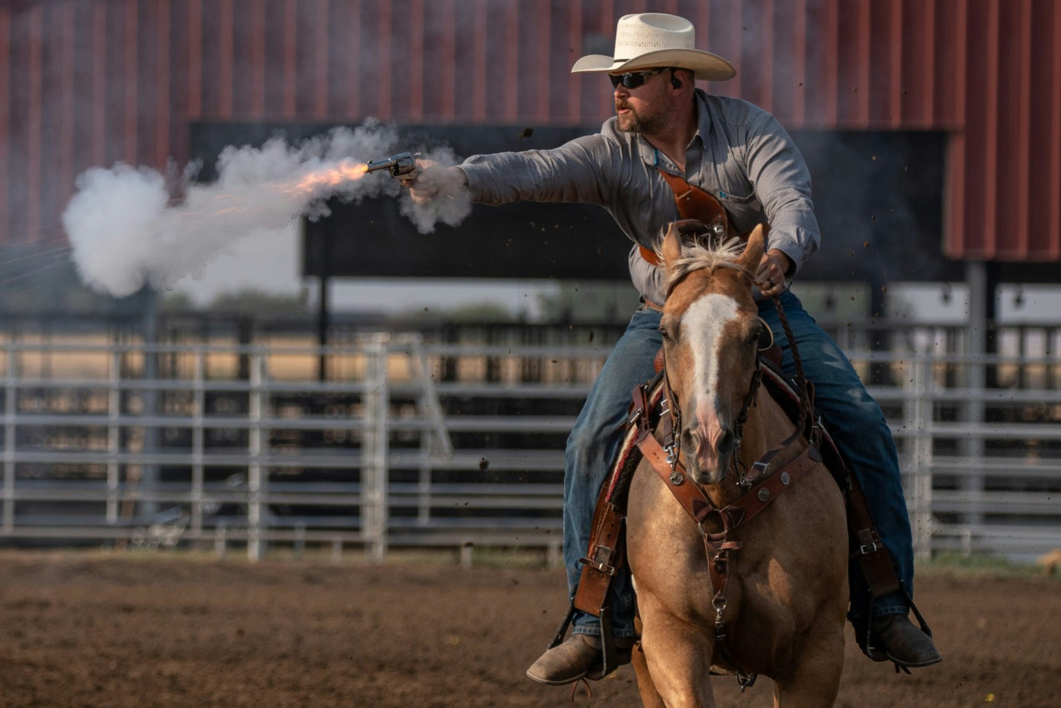 May contain: clothing, hat, person, gun, weapon, animal, horse, mammal, and equestrian