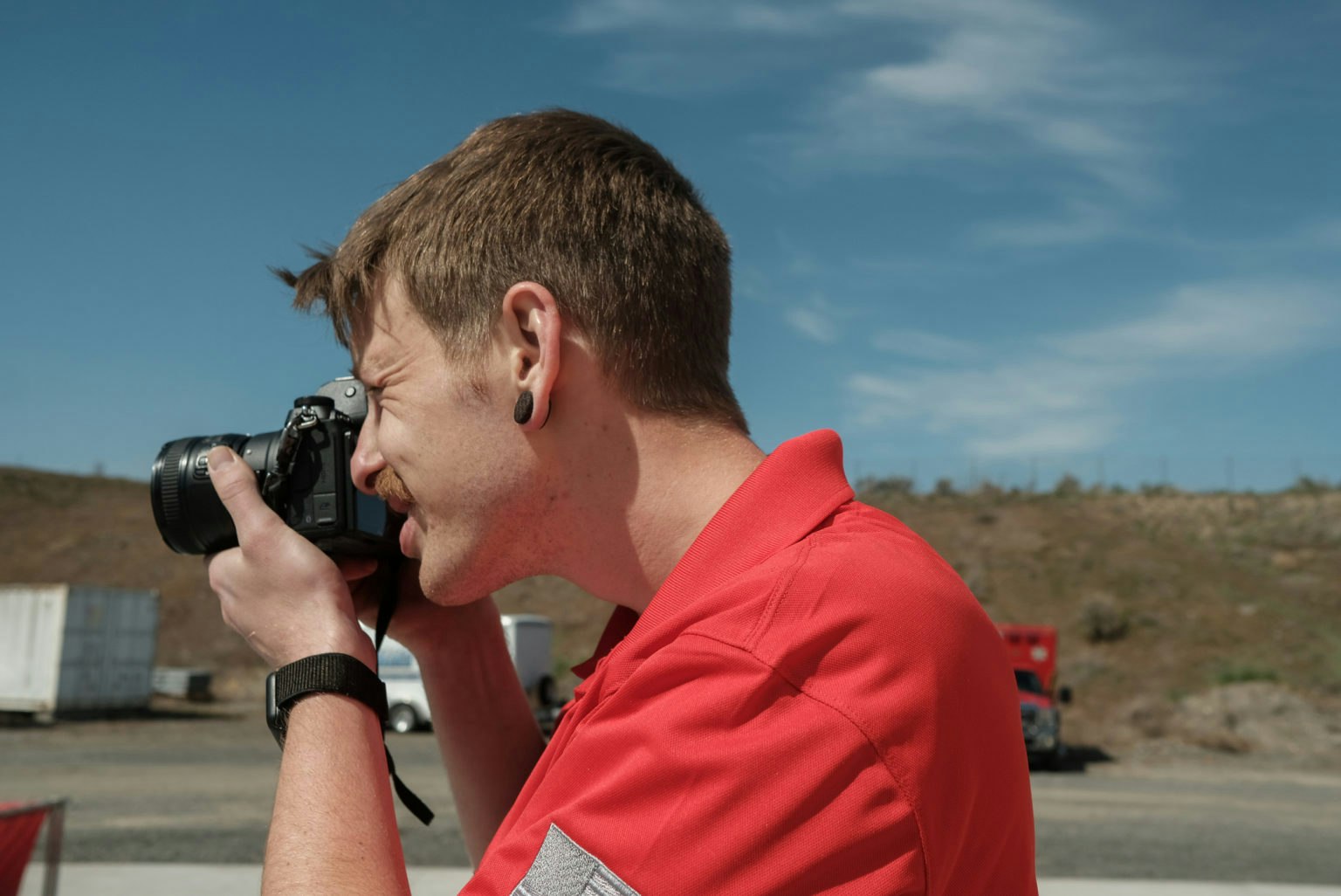 May contain: photography, person, photographer, camera, electronics, face, and head