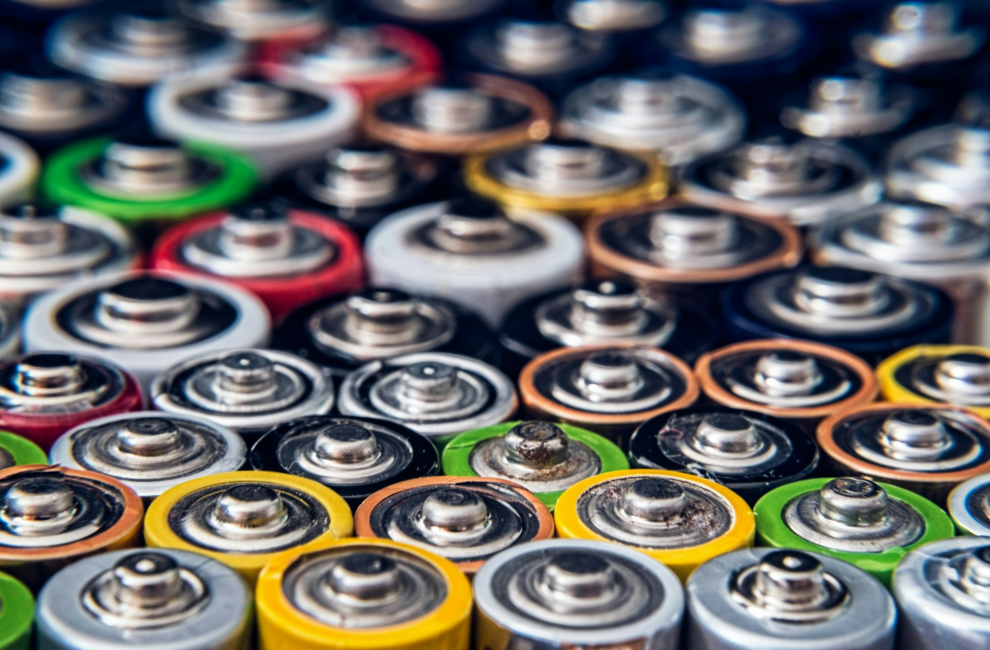 A collection of assorted battery tops in various colors and sizes, arranged in a close-up view.