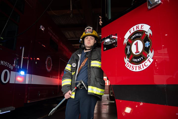May contain: fireman, person, helmet, clothing, coat, and jacket