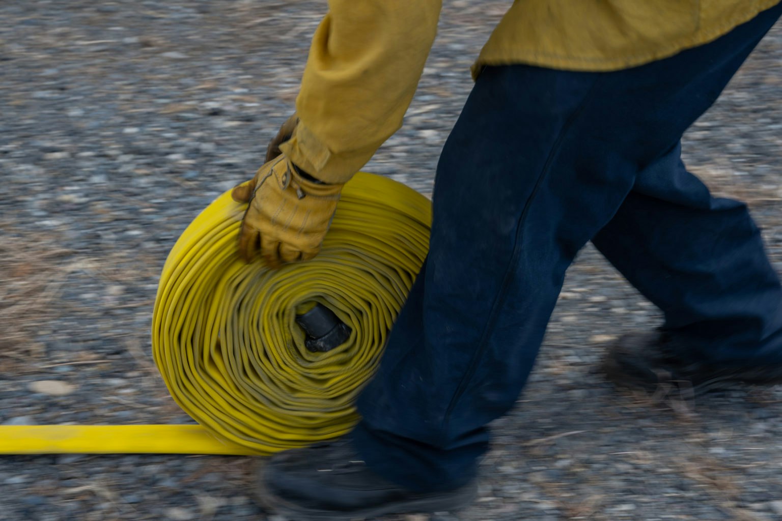 May contain: clothing, pants, person, road, hardhat, and helmet