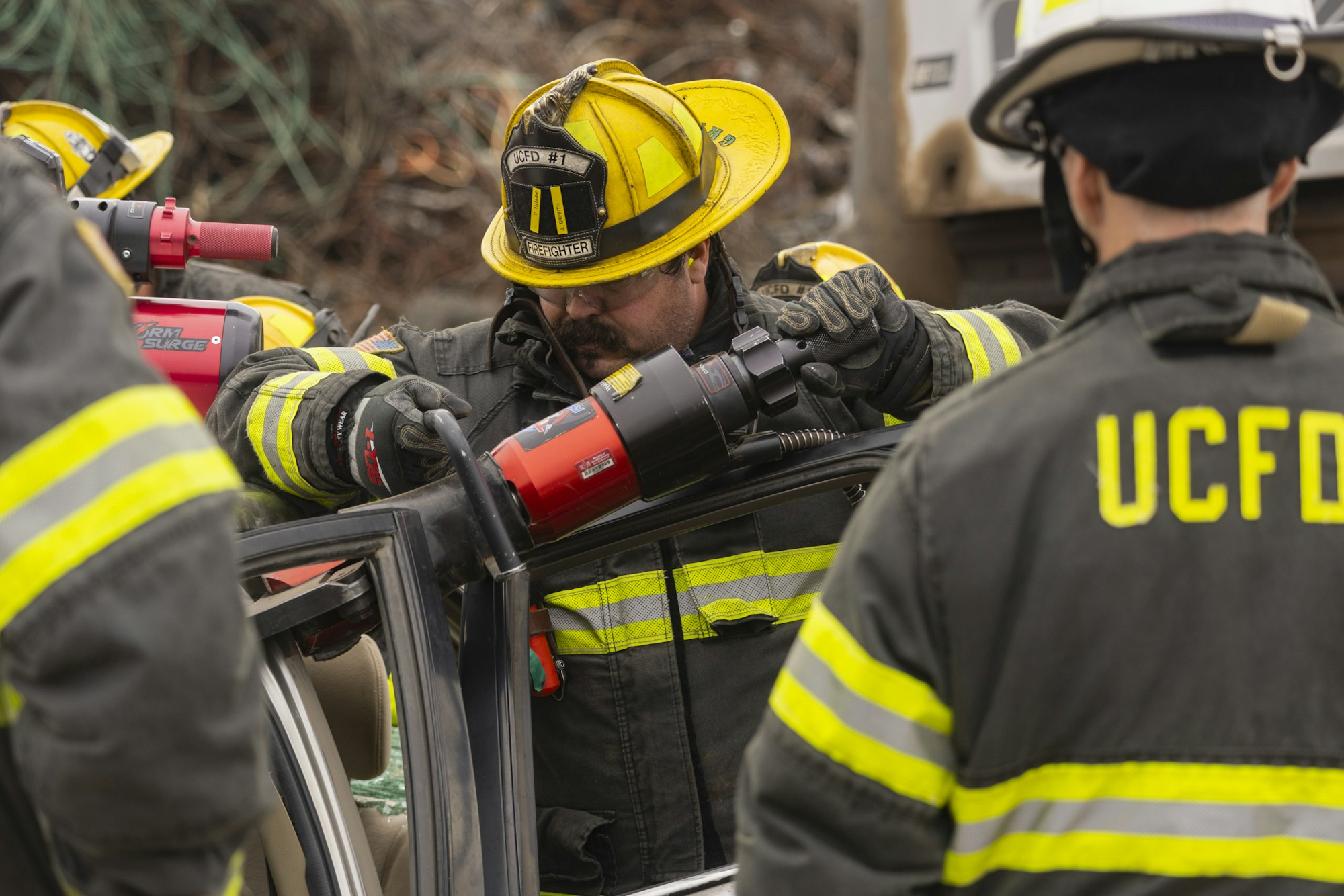 Firefighters using hydraulic tools for vehicle rescue.