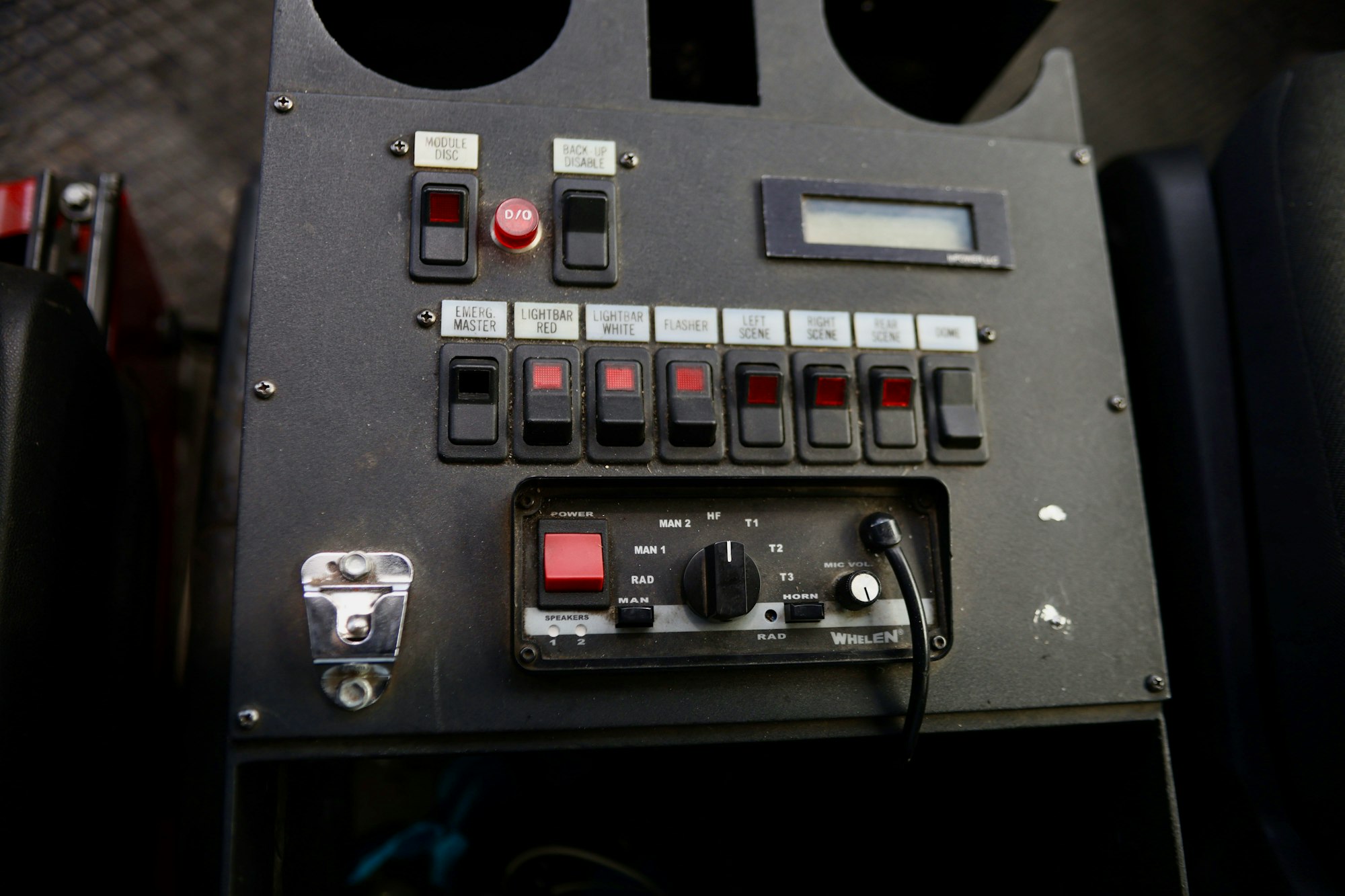 A control panel with switches labeled for lights, scenes, and sound; includes a microphone volume knob and power button.