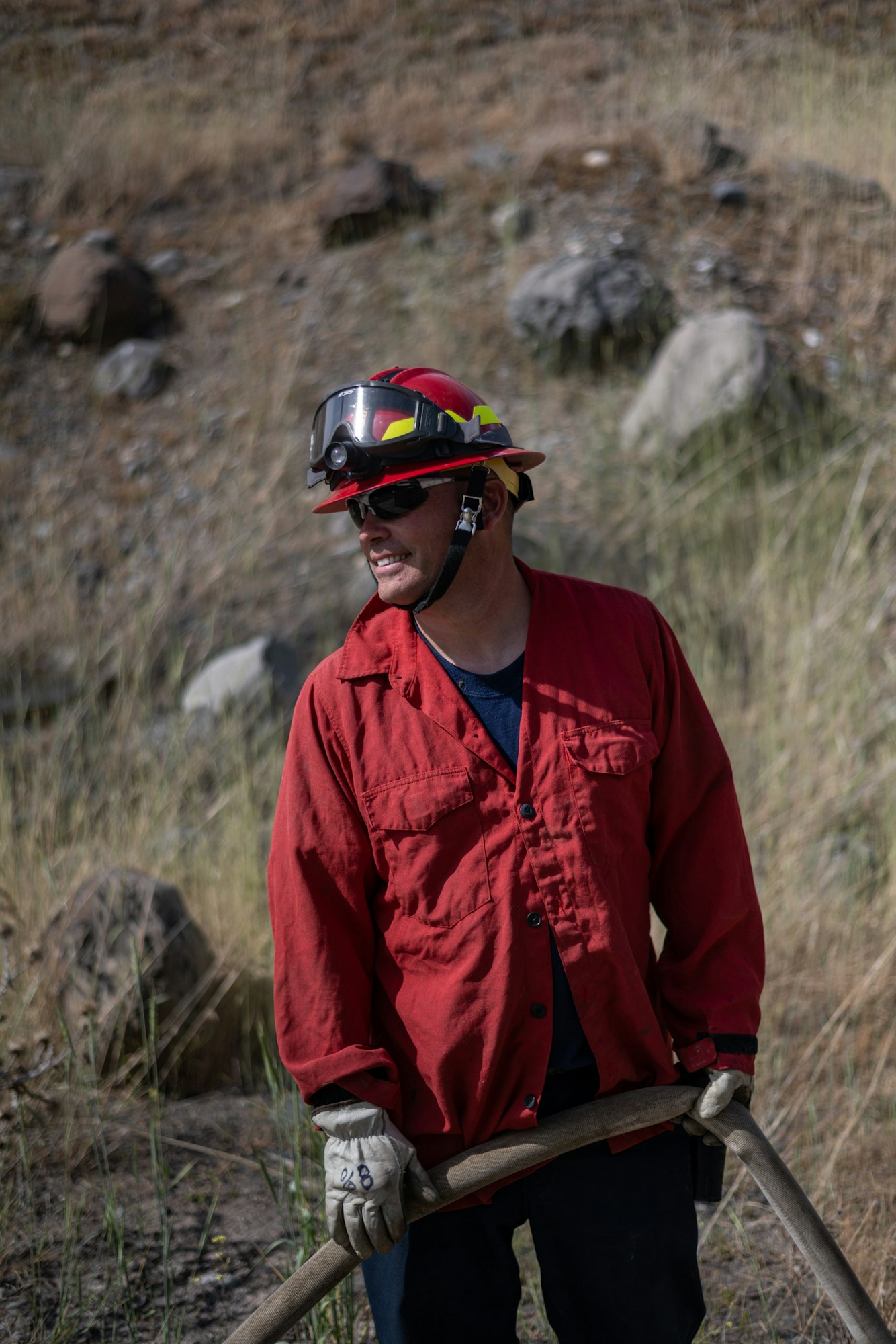 May contain: clothing, hardhat, helmet, glove, adult, male, man, person, accessories, and glasses
