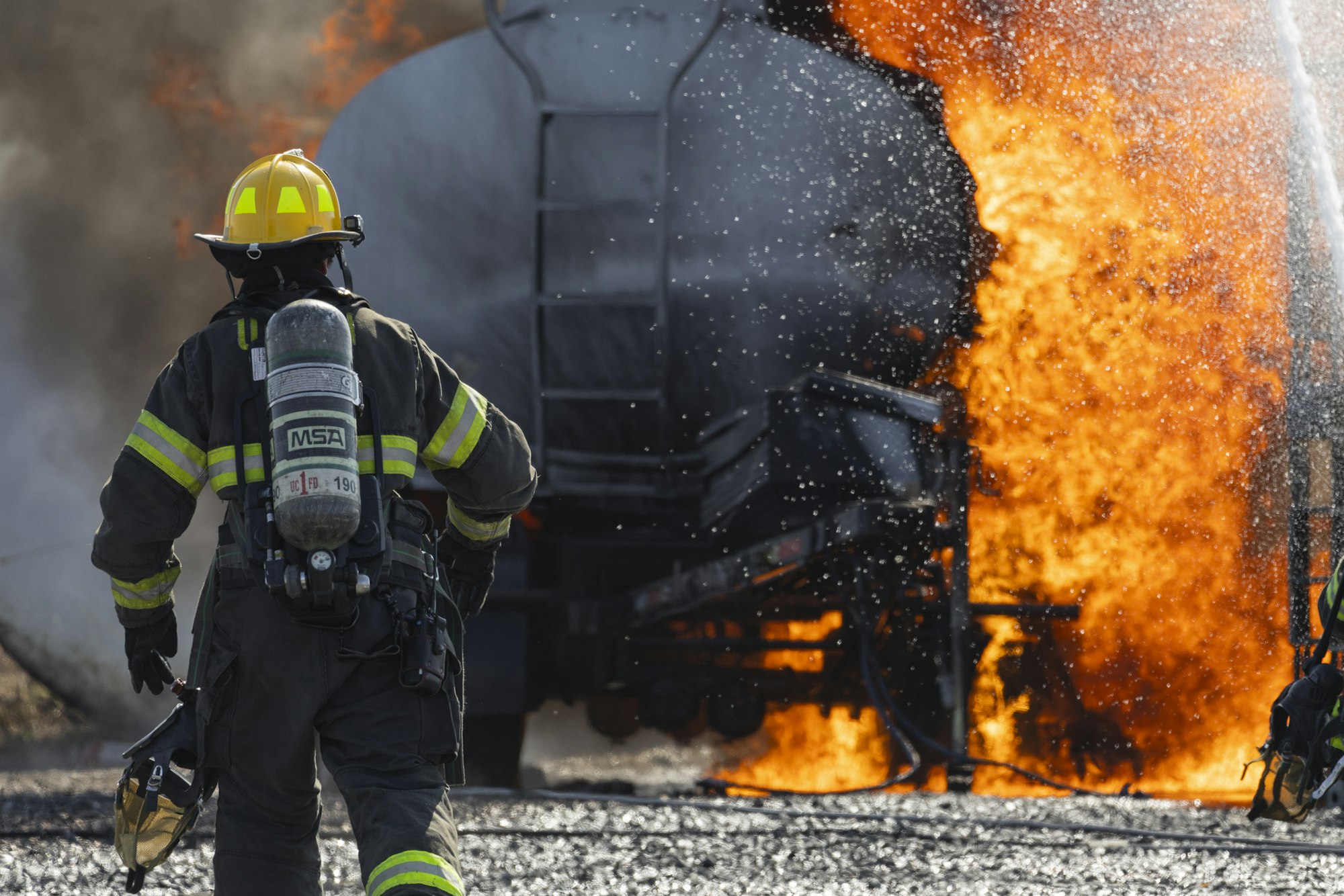 May contain: clothing, glove, helmet, person, fire, accessories, bag, and handbag
