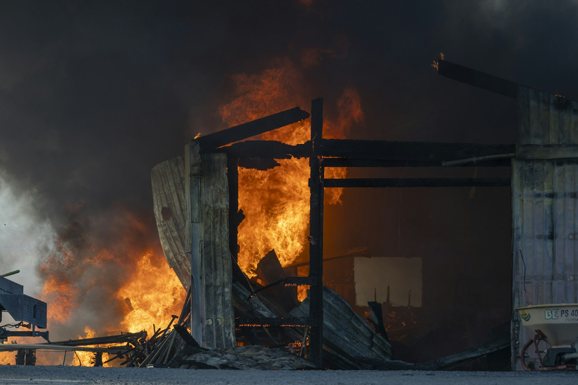 A building engulfed in large flames and thick smoke.
