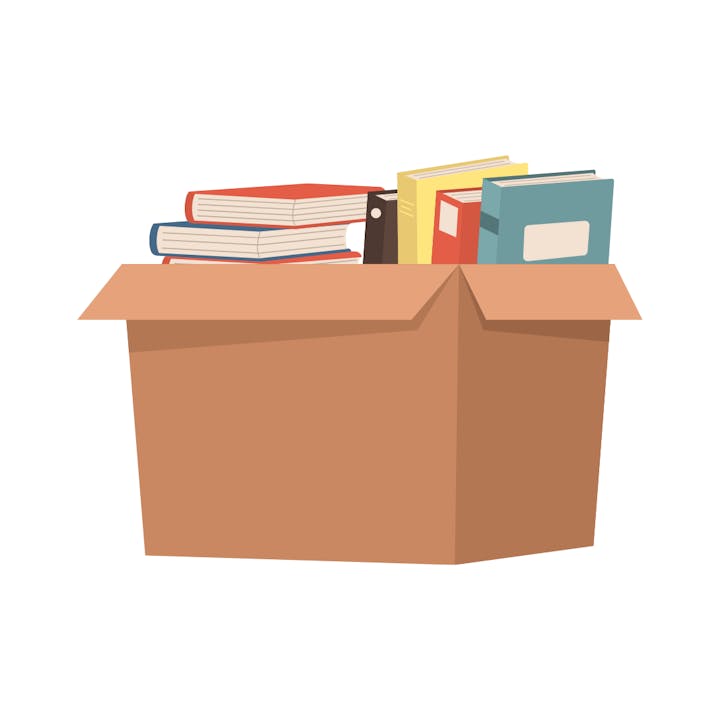 A cardboard box filled with various books.