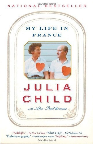 Cover of "My Life in France" by Julia Child, featuring a couple, hearts, and praise quotes.
