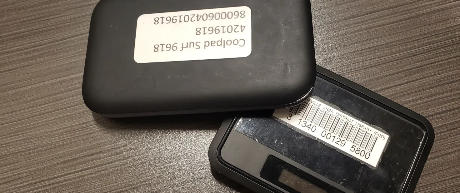 An open black case with a barcode sticker, possibly for a library.