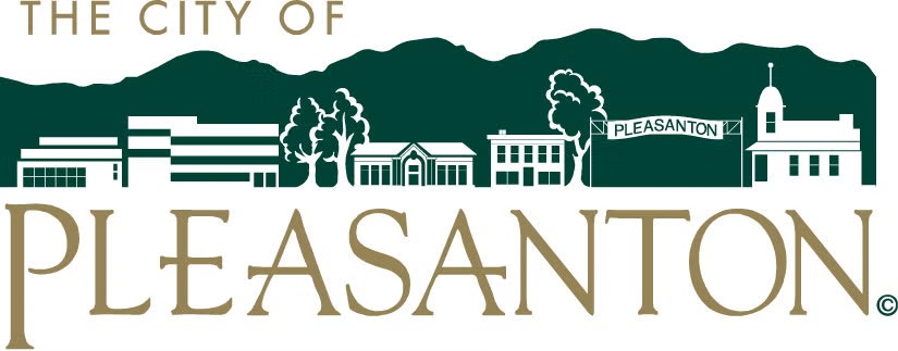The image displays a stylized logo for the City of Pleasanton, featuring buildings, trees, and mountains.