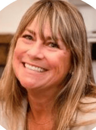 Person smiling, with long hair, in a casual setting.