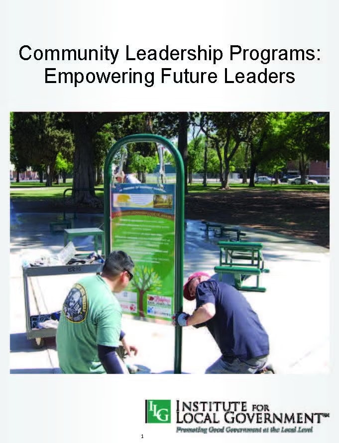Two people work on installing a sign in a park. The image promotes community leadership and is by the Institute for Local Government.