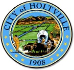 The image features the seal of Holtville, depicting agriculture, a wagon, and mountains, established in 1908.