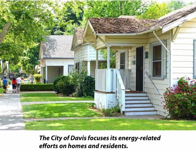 A residential street with houses and greenery, highlighting energy efforts by the City of Davis.