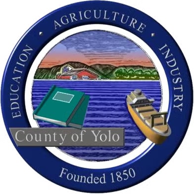 Seal of Yolo County with a landscape, book, and ship, highlighting education, agriculture, and industry. Founded 1850.