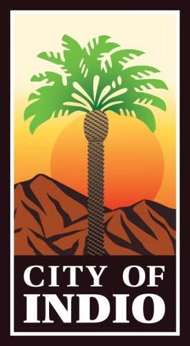 A logo with a palm tree, mountains, sunset, and the words "City of Indio."
