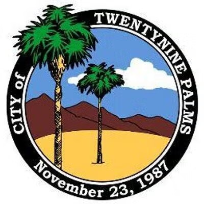 City seal for Twentynine Palms, featuring palm trees, mountains, and the date November 23, 1987.