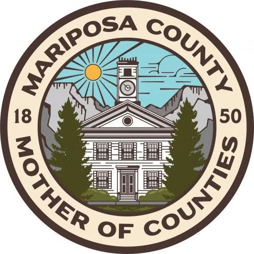 Crest of Mariposa County with a building, mountains, and sun; reads "Mariposa County, Mother of Counties, 1850."