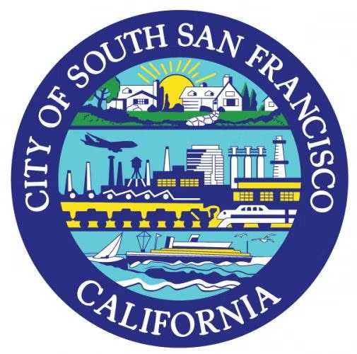 Seal of South San Francisco, California, depicting houses, an airplane, buildings, ships, and water, encircled by the city name.