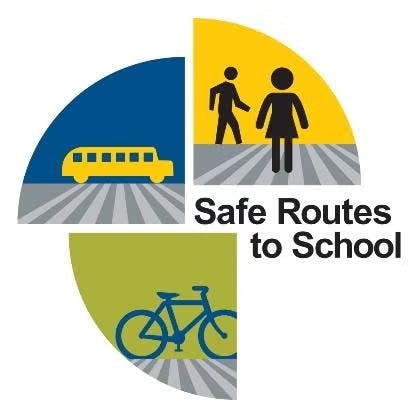 Logo for "Safe Routes to School" featuring a bus, pedestrian, and bicycle.