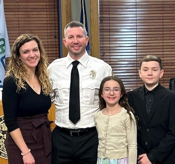 New Deputy Chief in his uniform and his wife, daughter, and son