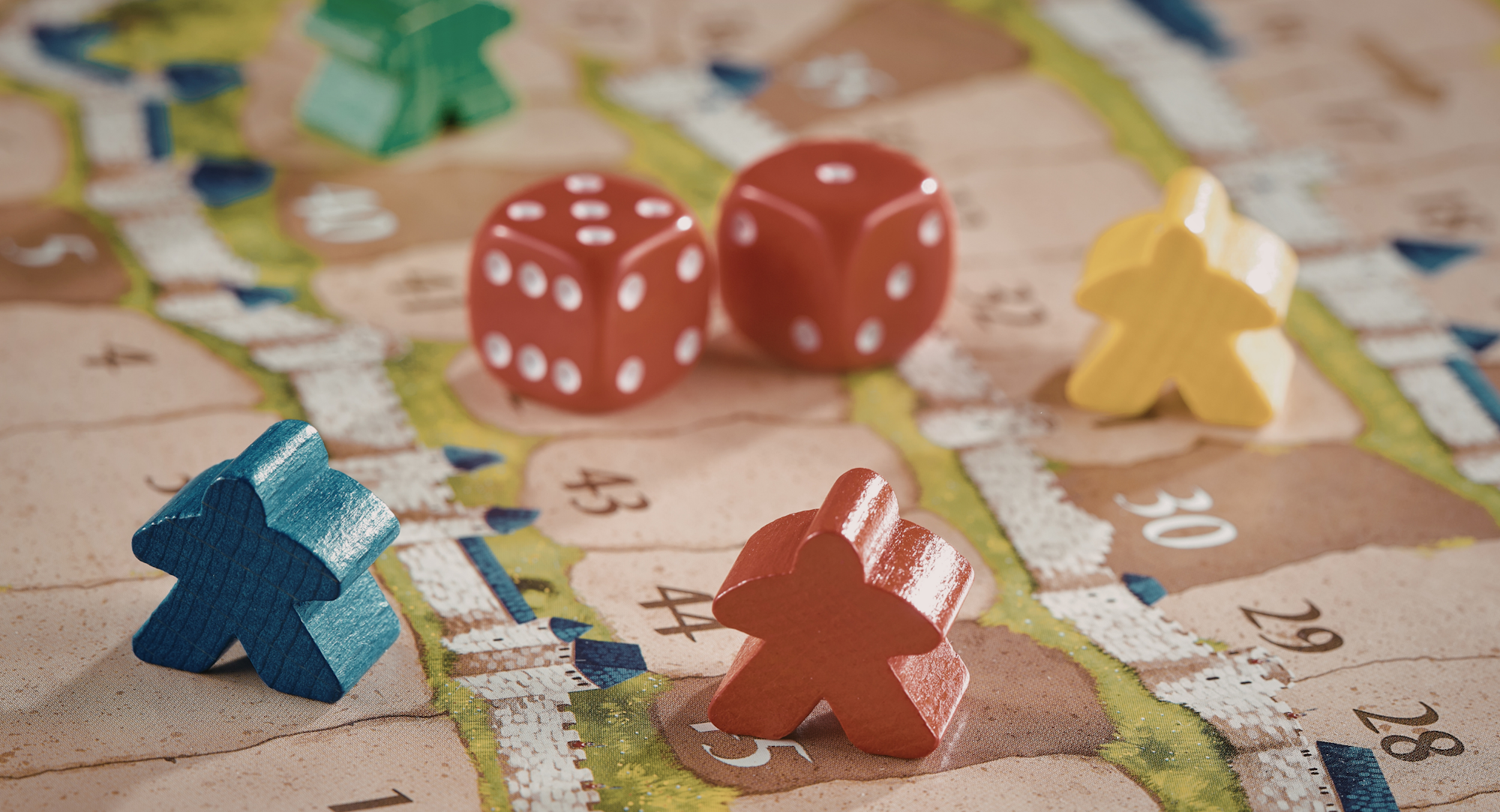 The image features a board game scene with colorful player pieces, two red dice, and a detailed game board.