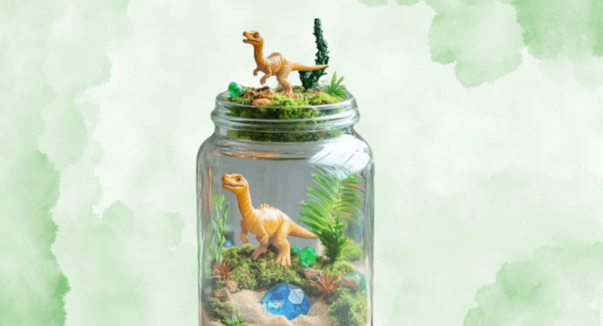 A creative terrarium featuring toy dinosaurs, moss, and decorative gems in a clear jar.
