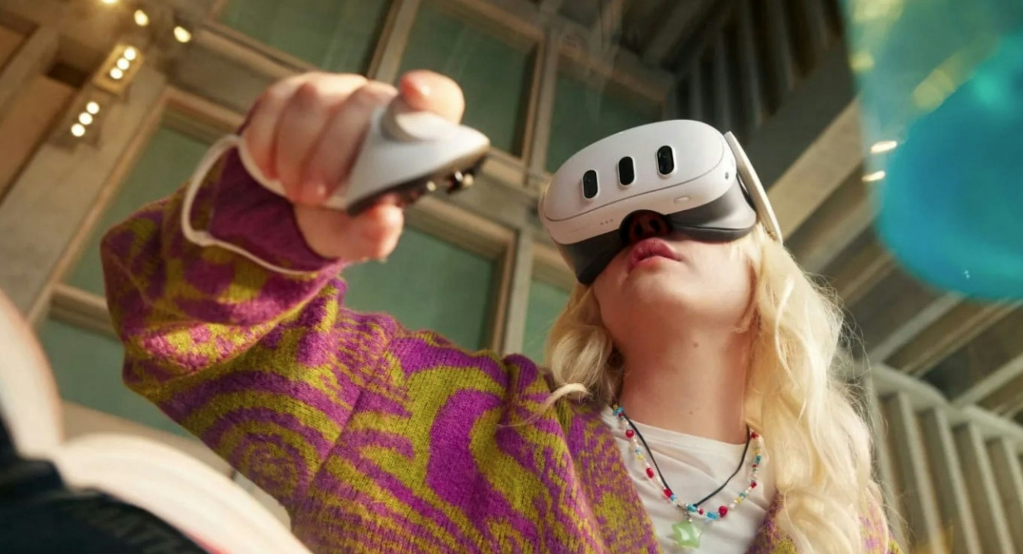 A person wearing a VR headset is interacting with a controller, set in a bright, modern environment.