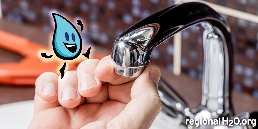 A person is about to turn on a shiny kitchen faucet, with a playful water droplet character next to their hand.