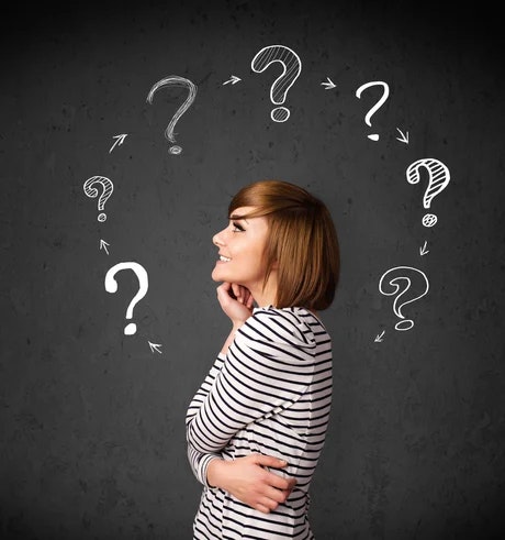 A person surrounded by question marks, suggesting curiosity or confusion.