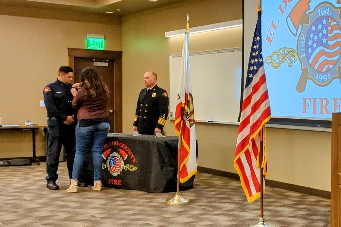 May contain: person, human, flag, symbol, pants, clothing, apparel, shoe, and footwear