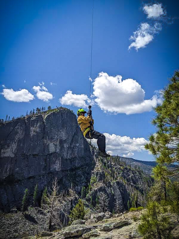 May contain: adventure, leisure activities, person, and ziplining